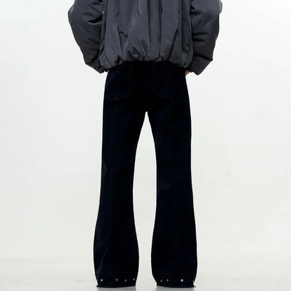 Pair of black straight-leg skinny jeans with a mid-rise waist and zipper fly on a neutral background.