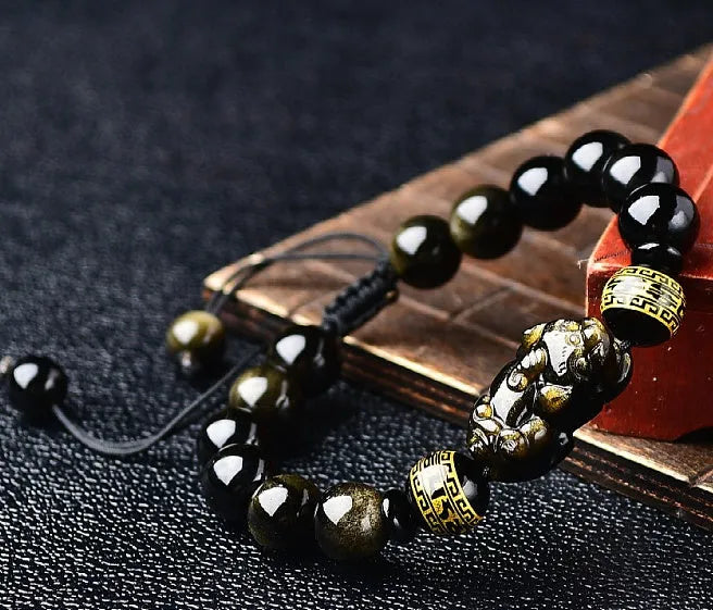Hand-woven golden obsidian Pi Xiu bracelet with animal design, showing bead size options.