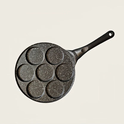Seven-hole aluminium barbecue plate with non-stick surface on gas hob