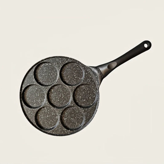 Seven-hole aluminium barbecue plate with non-stick surface on gas hob
