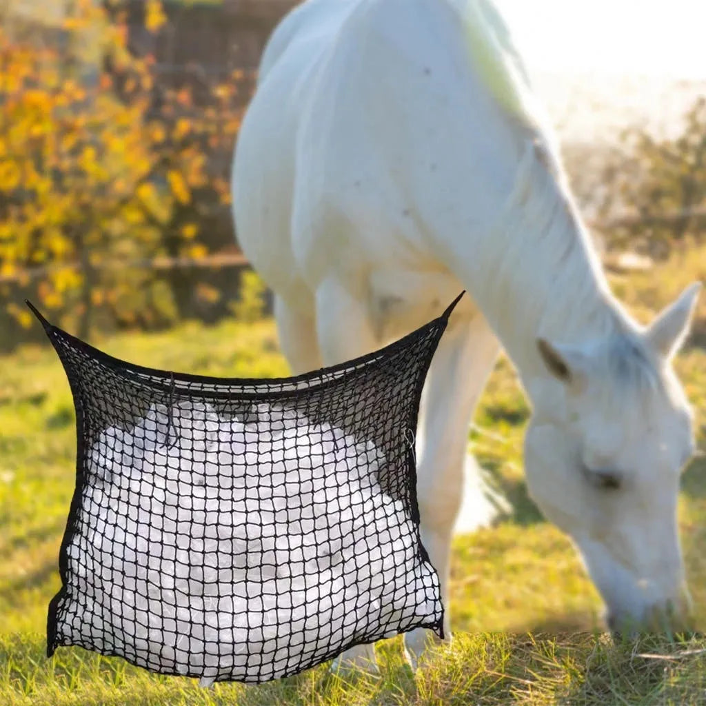Black woven grid hanging feeding bag for horses, shown against a stable background.