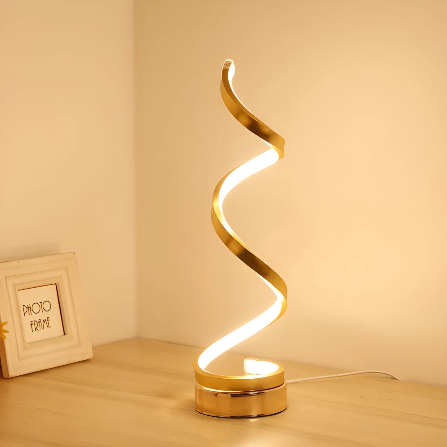 Black and white minimalist LED bedside lamp with aluminium shade and tri-colour dimming on a table