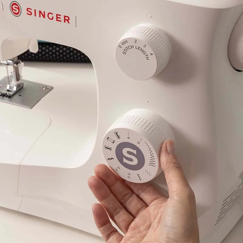 M2405 portable household sewing machine with accessories on table showing compact 47x39x26cm size