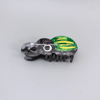 Handmade cartoon insect beetle grip hair clip or brooch in green, orange, or white designs.