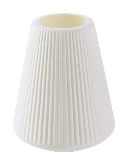 Melamine plastic decorative vase in blue colour measuring 16cm by 20cm on wooden desk