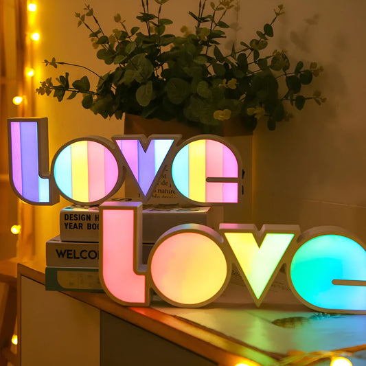 Rainbow halo LED love light with 'LOVE' word decoration on plastic casing.
