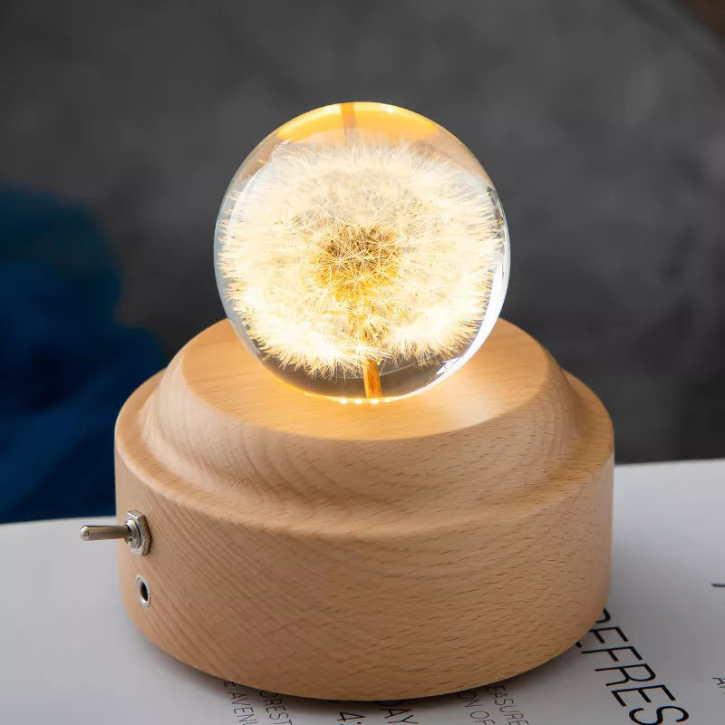 LED Dandelion Crystal Ball Night Light with oak base emitting soft glow