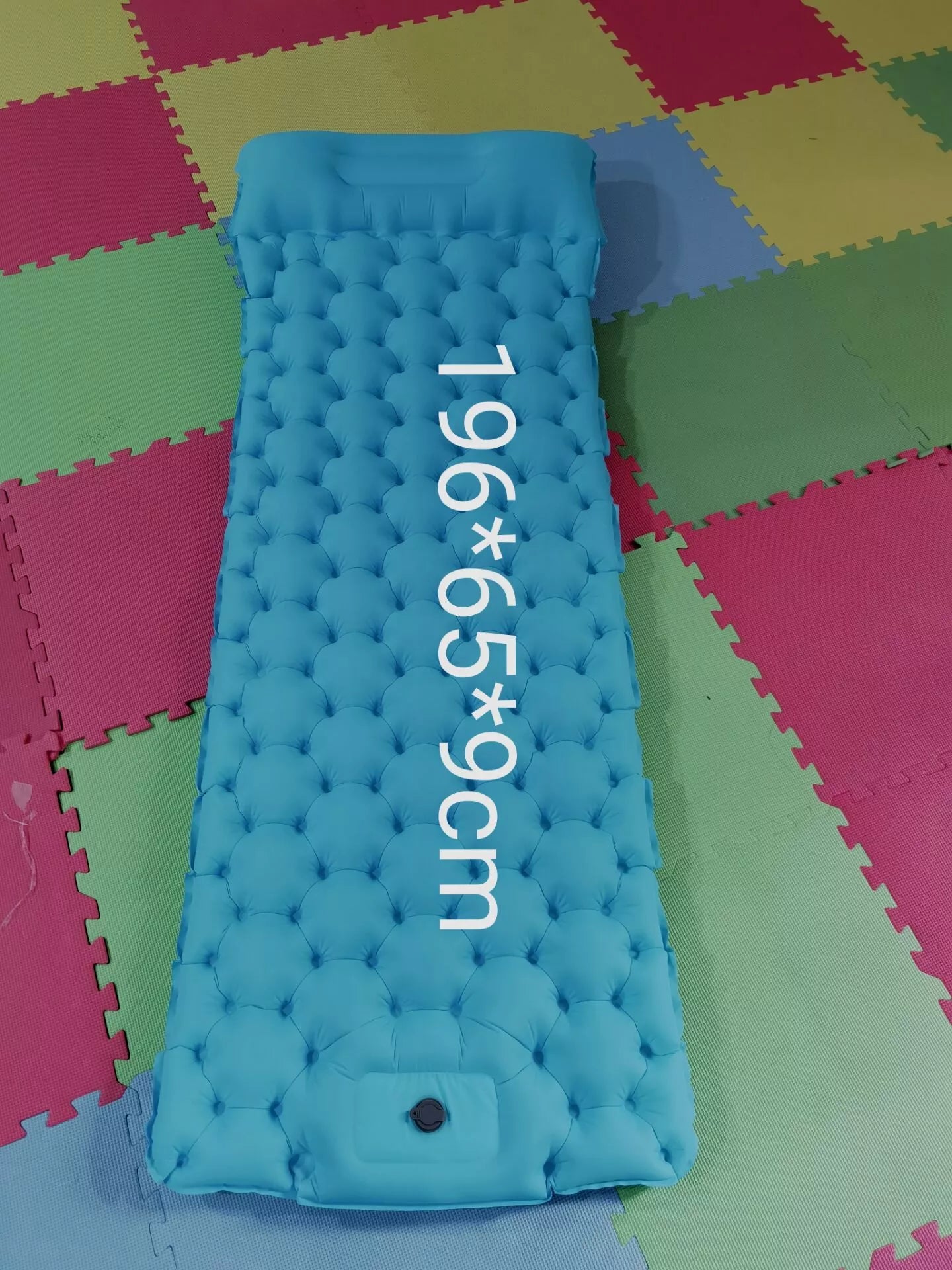 Portable inflatable camping cushion with built-in foot pump in various colors