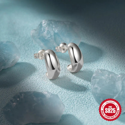 C-shaped sterling silver earrings with glossy electroplated finish in gold or white gold options