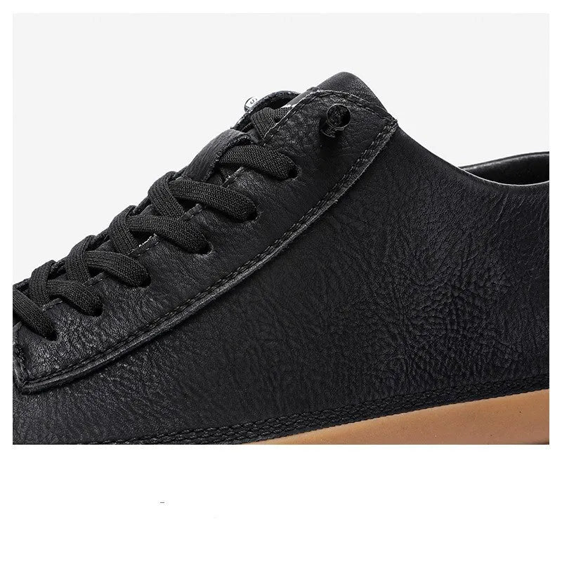 Men's black casual shoes with round toe, lanyard closure, and soft rubber soles on a neutral background