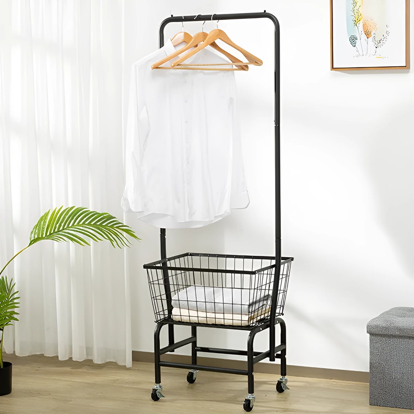 White mobile clothes storage rack with swivel casters and a single long hanging rod for shirts and trousers.