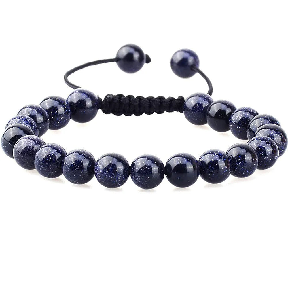 Close-up of a women's flat knot braided healing bracelet hand-woven with colourful gemstones.