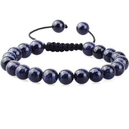 Close-up of a women's flat knot braided healing bracelet hand-woven with colourful gemstones.