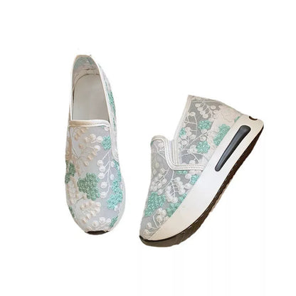 Women's lace mesh high heel sneakers in green and pink with slope heel design