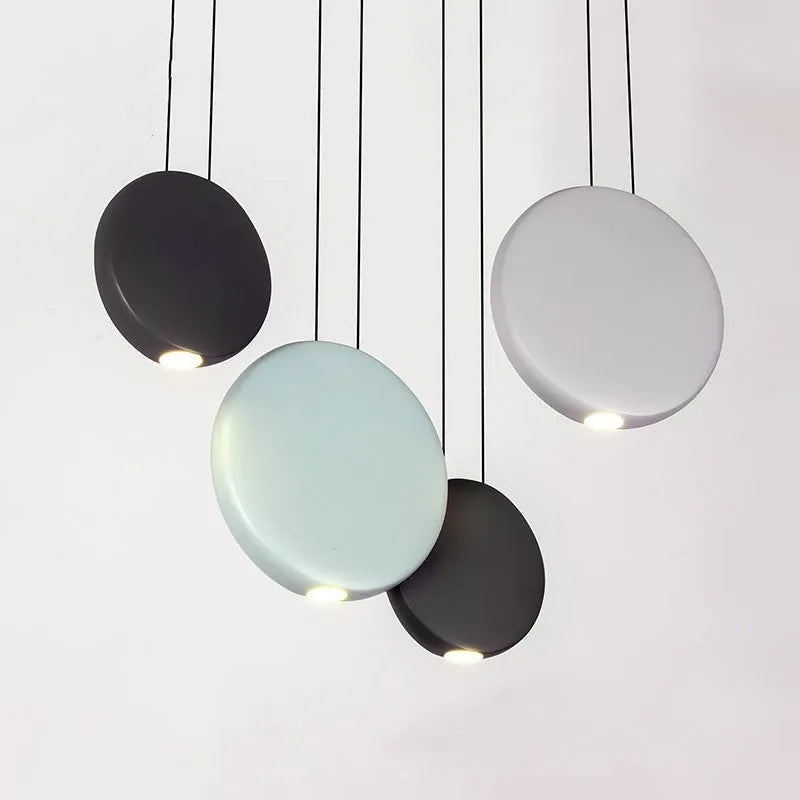 Round resin cosmos chandelier light with adjustable hanging height, shown in a bedroom setting.