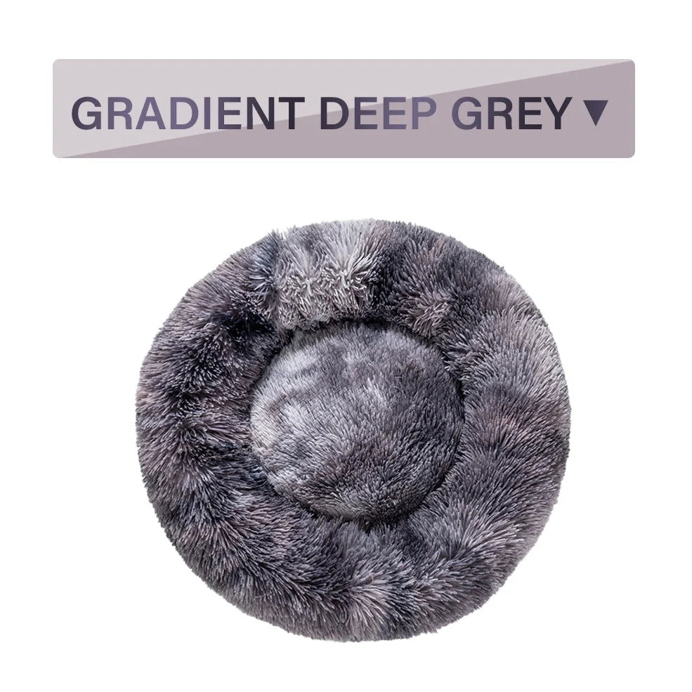 Fluffy donut-shaped dog bed in dark grey colour with raised edges, showing plush texture and circular design