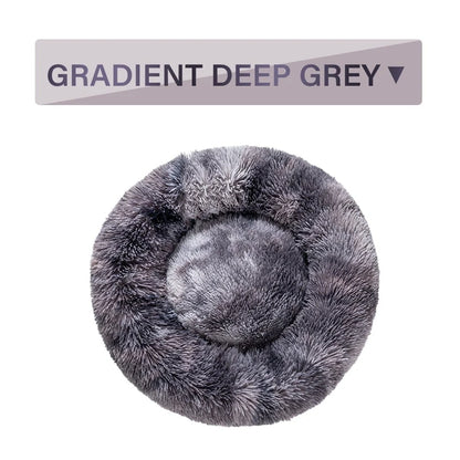Fluffy donut-shaped dog bed in dark grey colour with raised edges, showing plush texture and circular design