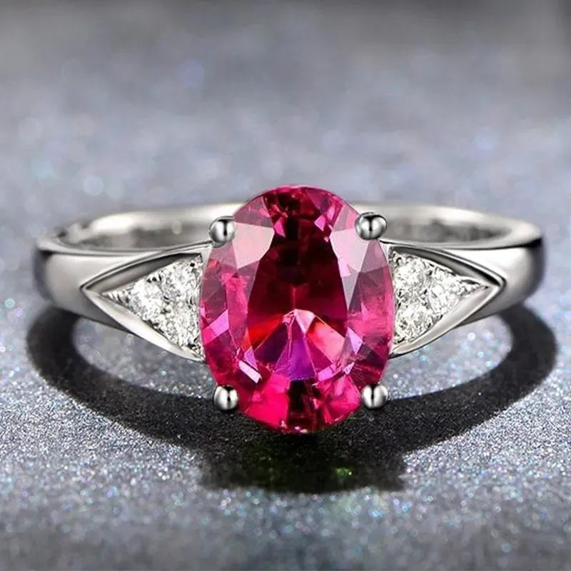 Women's zircon ring with natural blue or red zircon inlay, showing heart, water drop, or bell pattern on court style band.