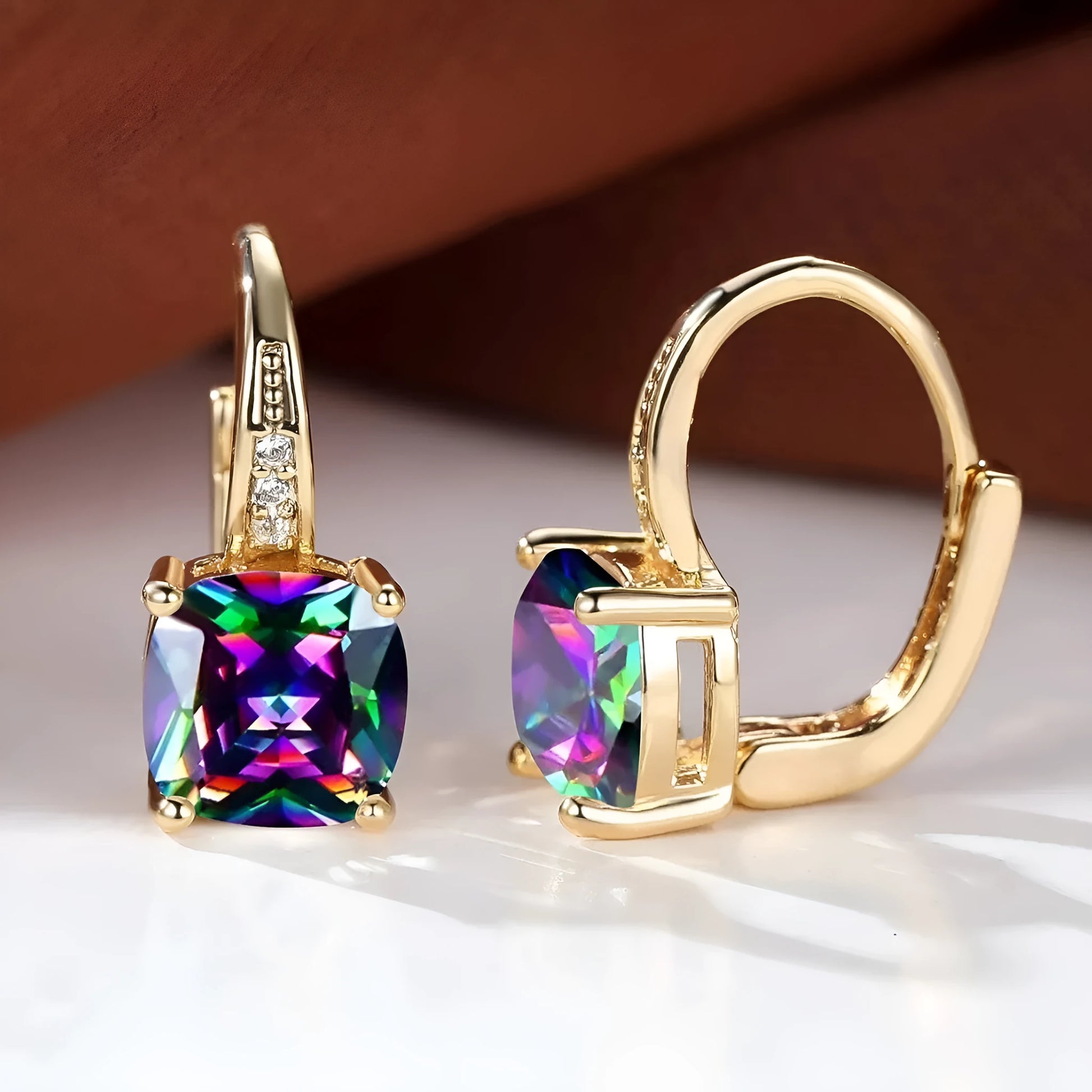 Square geometric ear clips with colourful moissanite inlays and a metallic electroplated finish.