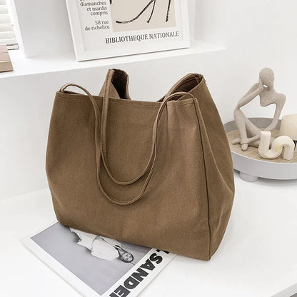 Solid colour women's canvas handbag with double shoulder straps showing internal mobile phone compartment