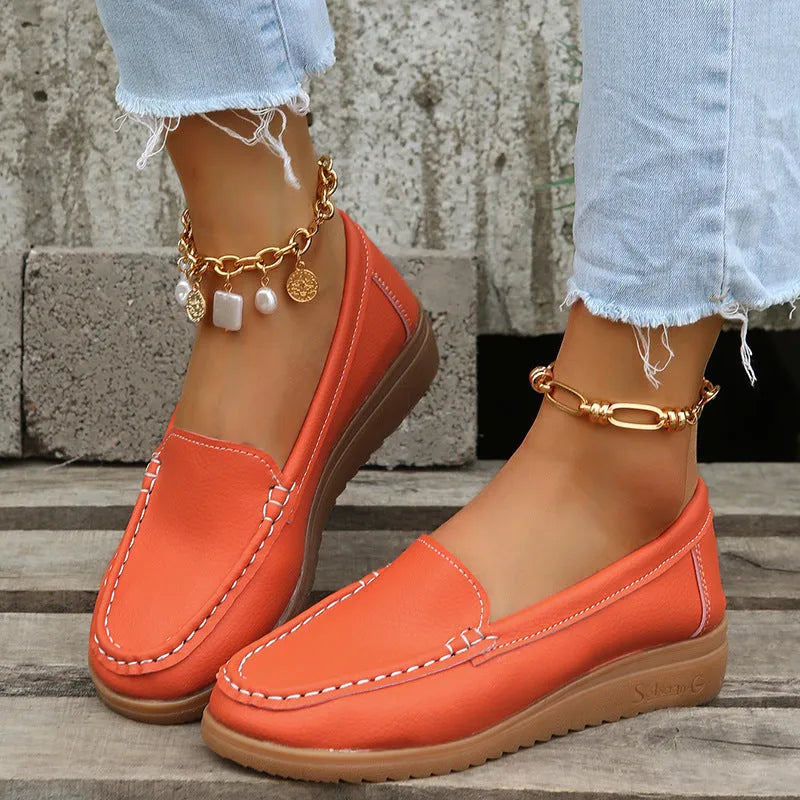 Women's flat shoes with car suture detailing on PU leather upper, round toe, rubber sole, available in multiple colours