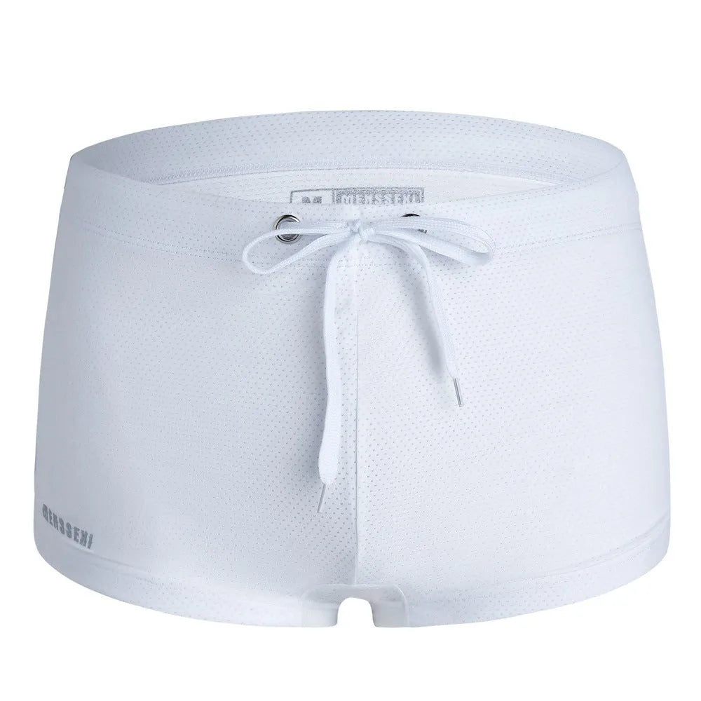 Men's low waist boxer style swimming trunks in nylon, available in multiple solid colours.