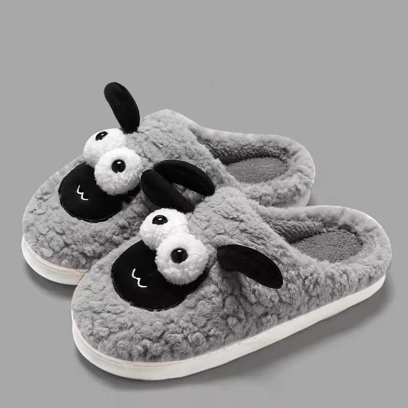Brown suede slip-on slippers with thermal cotton body and sewn PVC sole on a wooden floor.