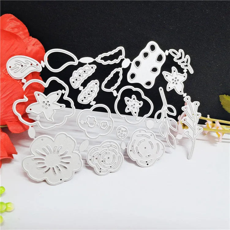 Silver carbon steel flower paper cutting mould measuring 14.3 by 9.9 cm with etched plant design