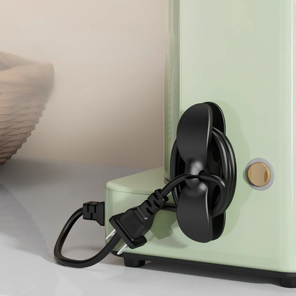 Black TPU cable organizer clips winding appliance cords on kitchen counter, 5cm size, non-marking adhesive for tidy management