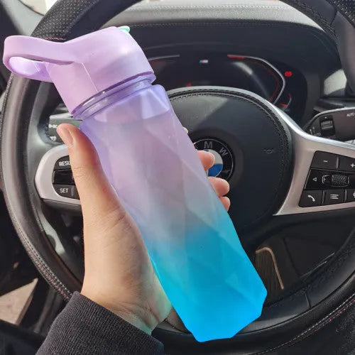 Large plastic spray water bottle with handle strap and leakproof lid in green colour.