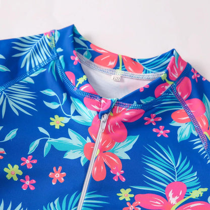 Girl's long-sleeve one-piece swimming suit in a briefs style on a hanger.