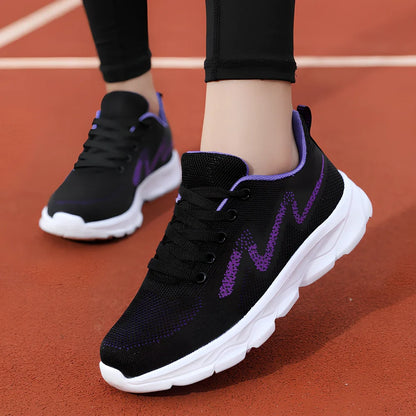 Women's black sneakers with mesh upper, wedge heel, and lace-up front