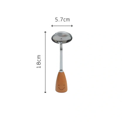 Twelve-piece stainless steel kitchen tools with beech handles and smiley motifs on a kitchen counter