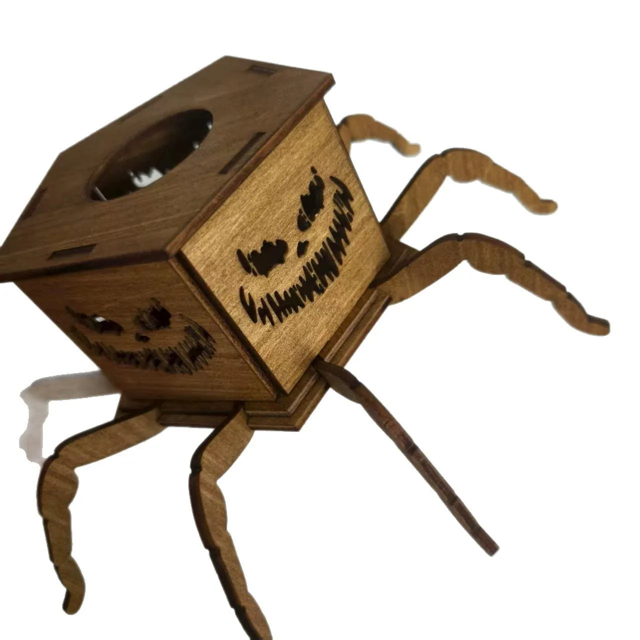 Dark stained wooden lantern candlestick with carved spiderweb design, holding a white taper candle.