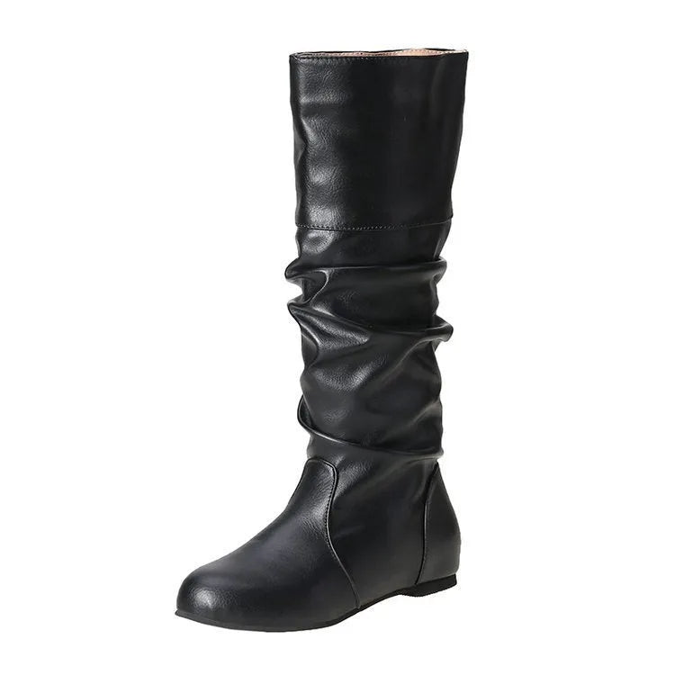 Women's flat slip-on boots in black with round toe and high cylinder shaft on a neutral background.