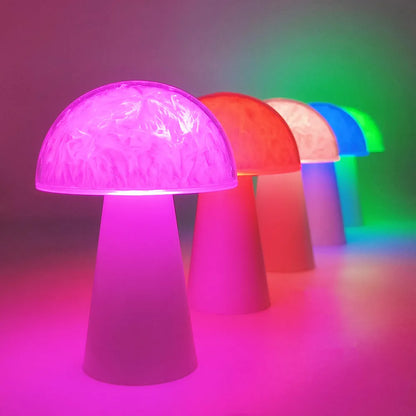 Mushroom-shaped RGB colour-changing night light with remote control on a wooden surface