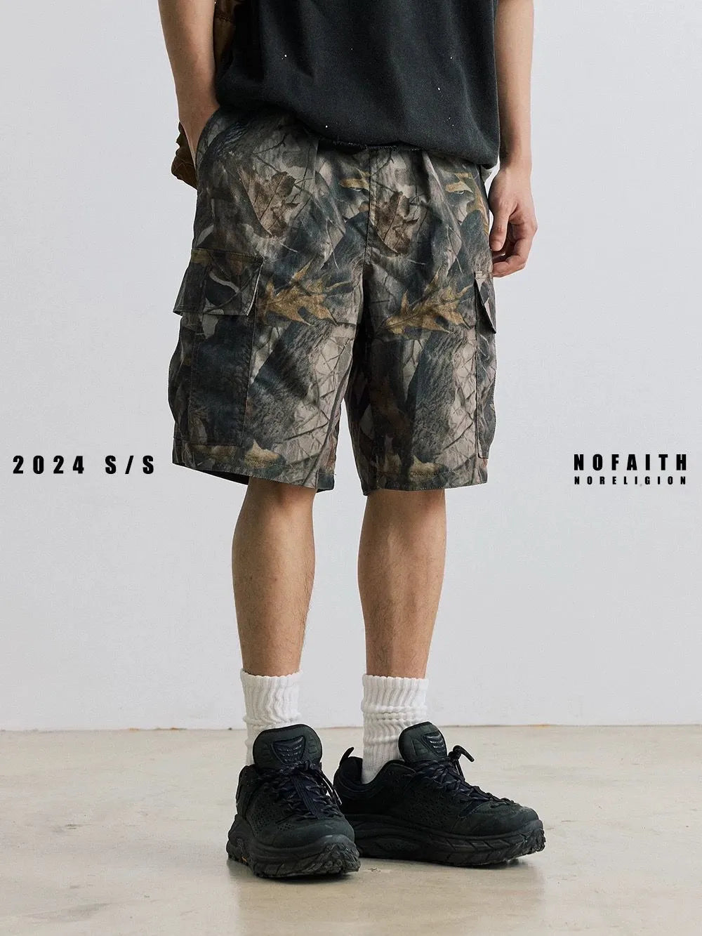 Loose straight-leg denim shorts for teenagers in army green, showing elastic waistband and zip fly.