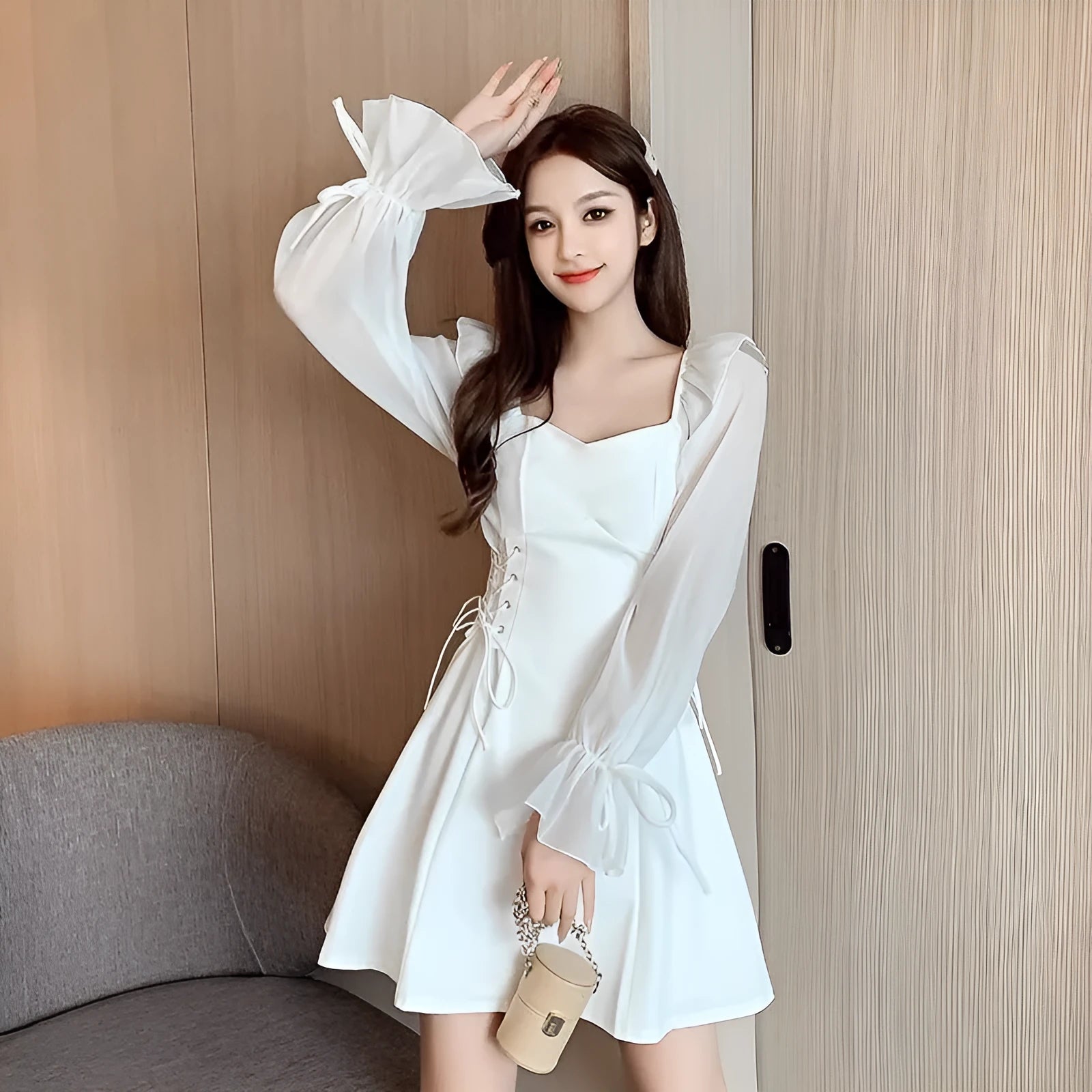 White chiffon patchwork dress with long sleeves and a waist-slimming design on a mannequin.