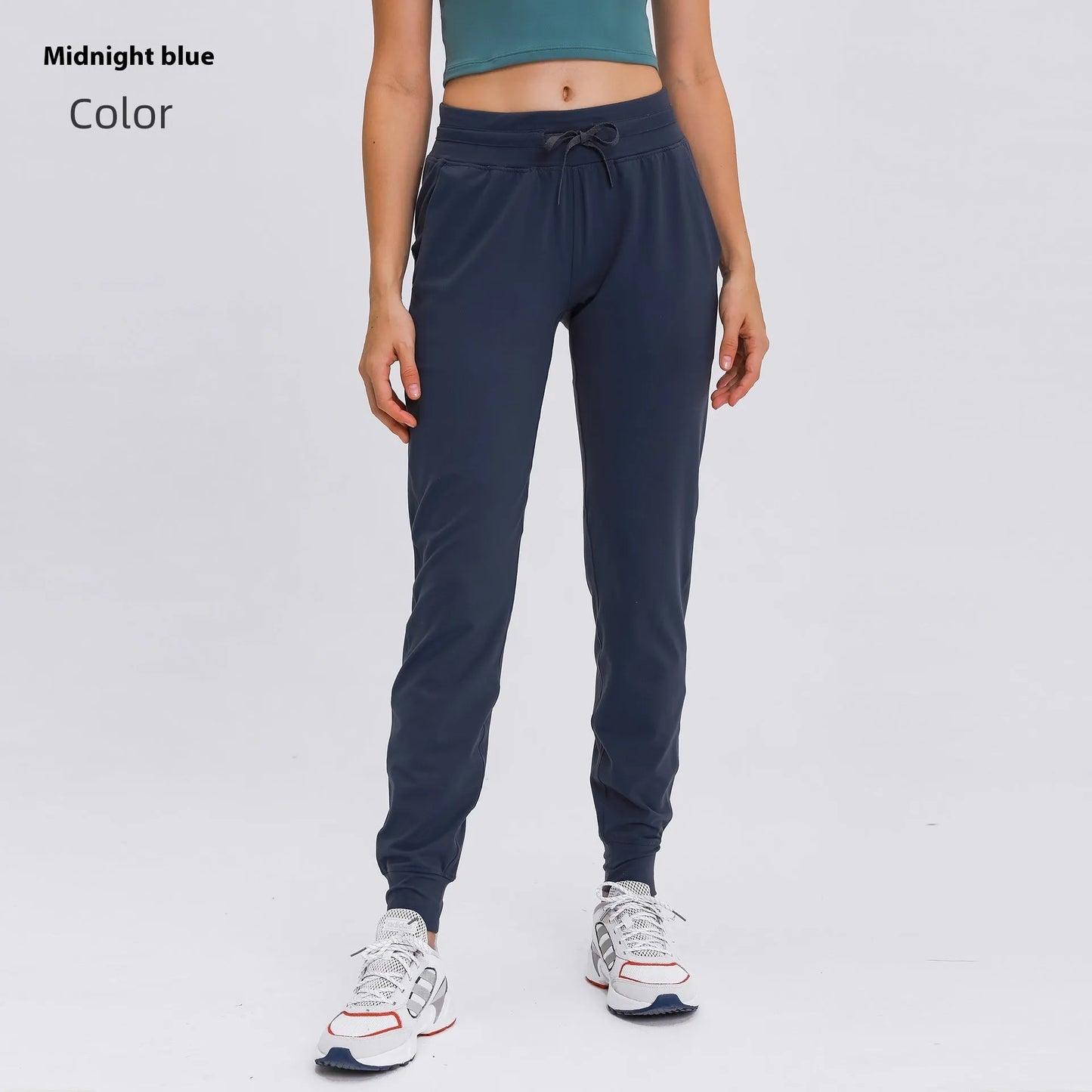 Women's high waist yoga pants with drawstring waistband in Belgian blue colour, showing stretch fabric during yoga pose