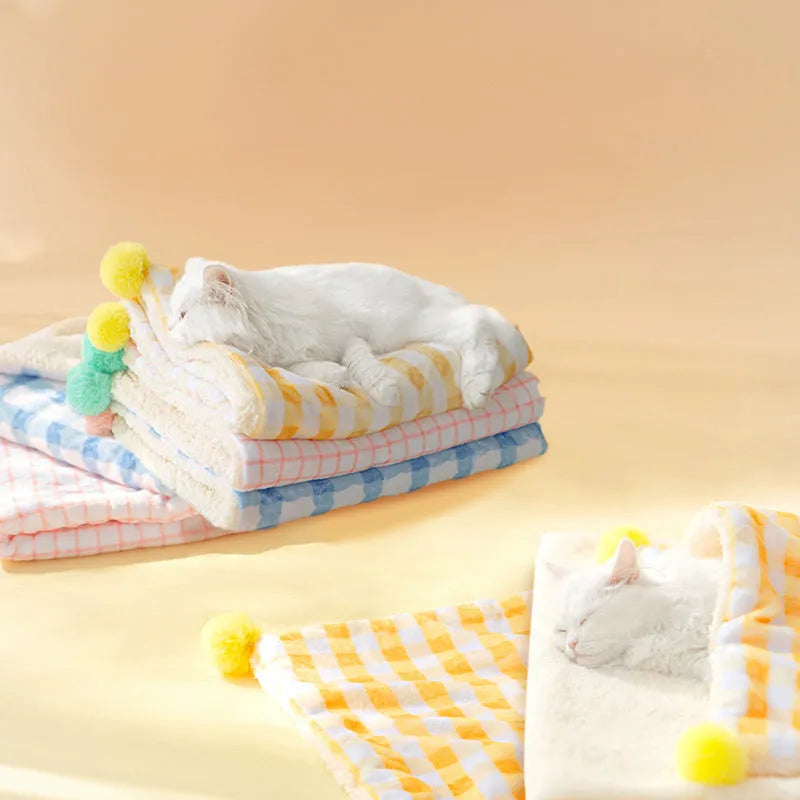 Blue coral fleece pet blanket shown in a Large size (70x50cm) on a wooden floor.