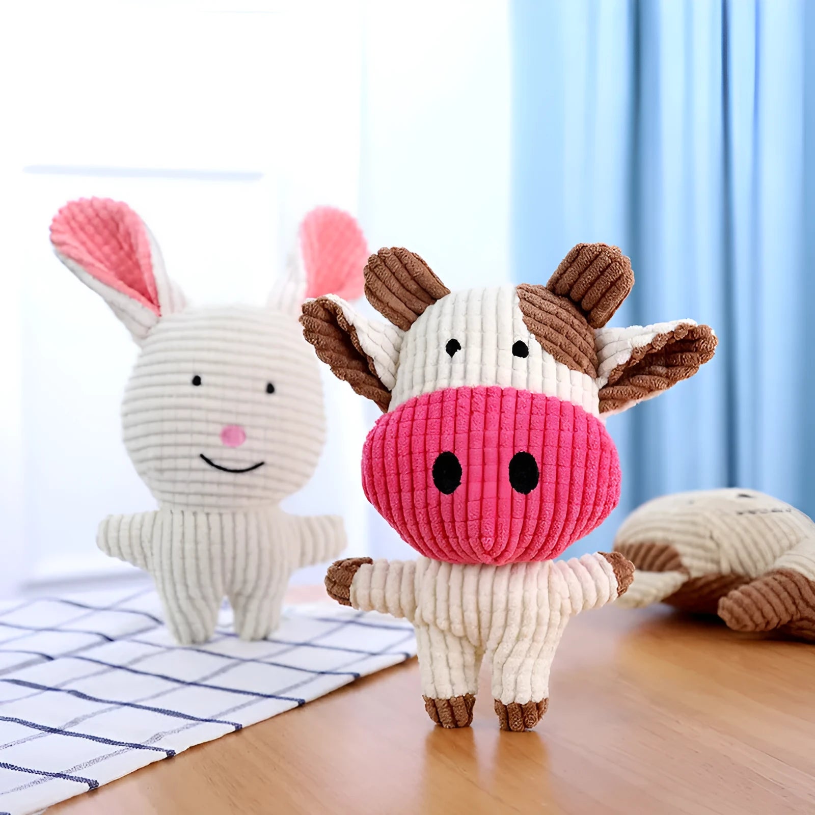 Animal shaped plush dog chew toy with squeaker in bright colours