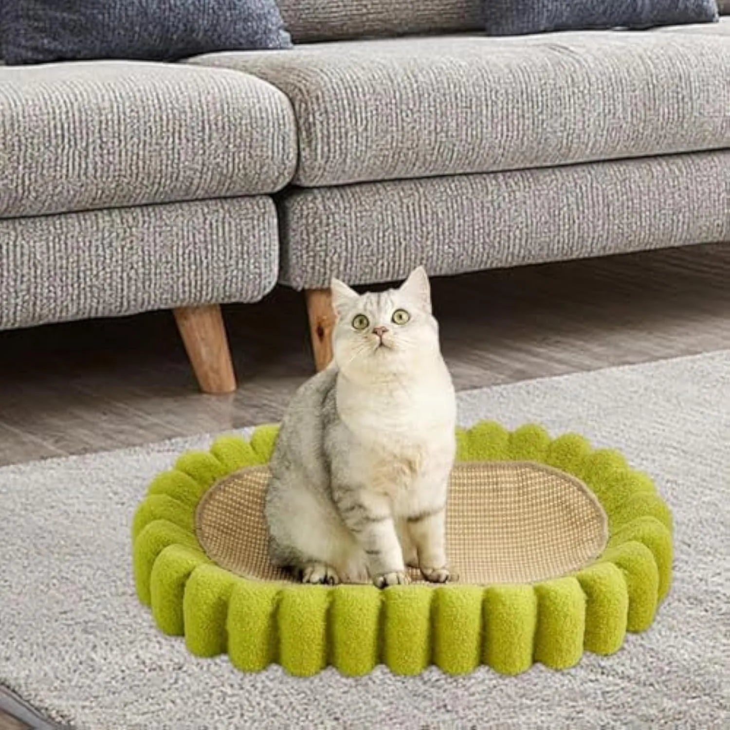 Green oval-shaped sisal cat scratching pad with a central bowl, serving as a cat bed and furniture protector.
