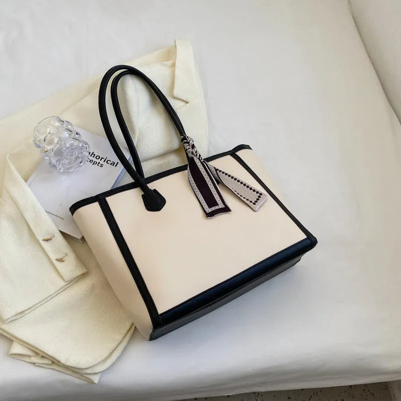 Soft PU shoulder tote bag in black with open outer pockets and internal organisation compartments