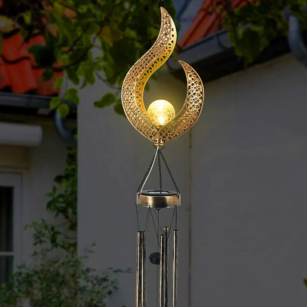 Solar wrought iron wind chime lamp with hollow flame design for garden lighting