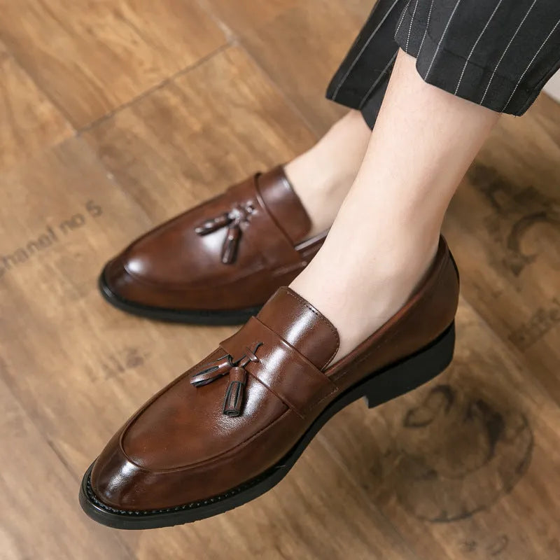 Men's black and brown business casual slip-on shoes with tassel detail and pointed toe