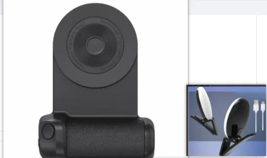 Black magnetic phone camera grip holder with rotatable stand on a table next to a smartphone.