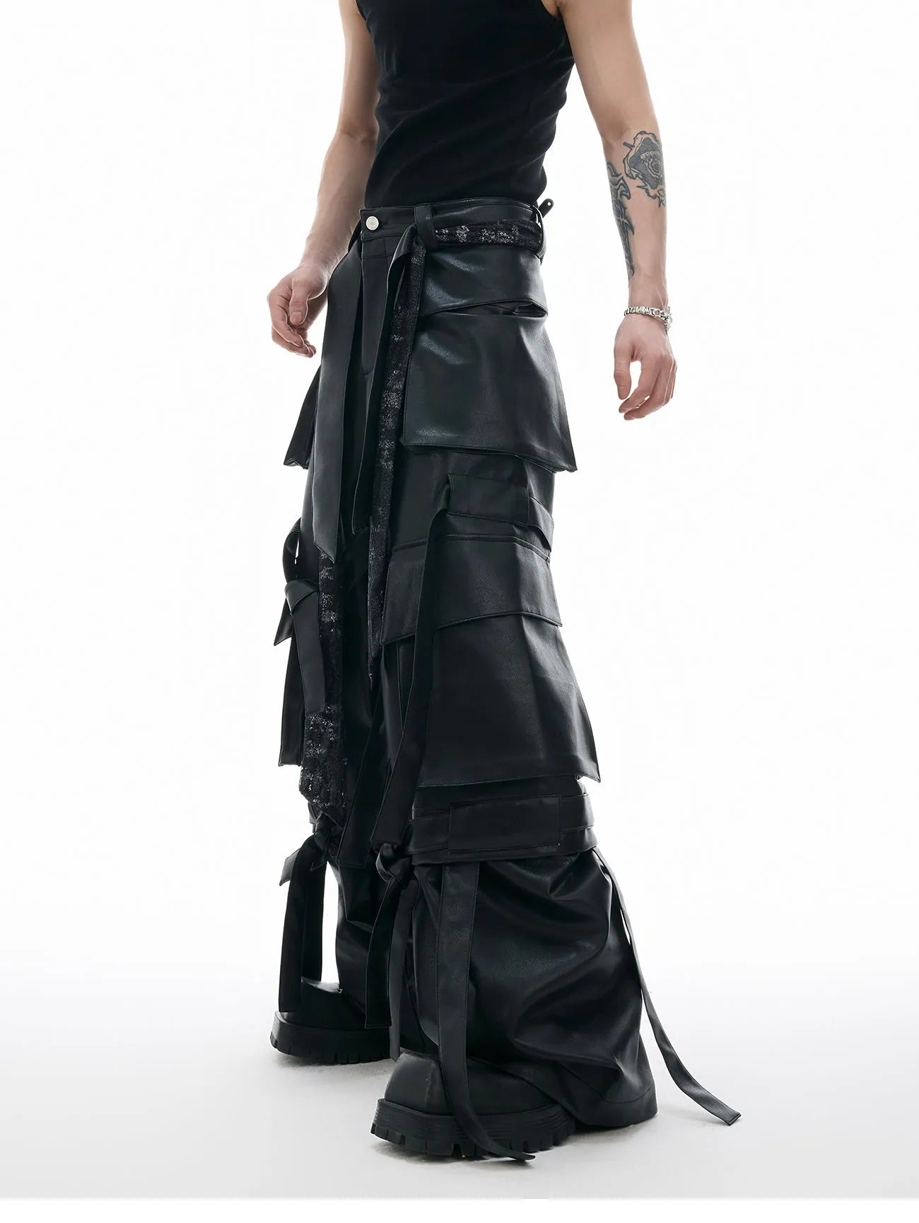 Black loose-fit trousers with quilted texture, multiple pockets, and stitching ribbon leather accents on model