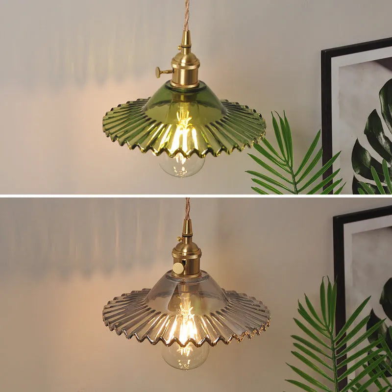 Retro brass lotus wall lamp with copper body and glass shade in various colours, mounted on a wall