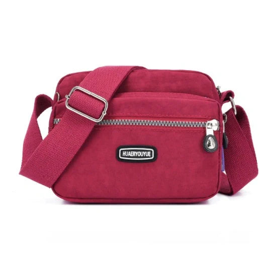 Compact nylon messenger bag in various colors with multiple compartments