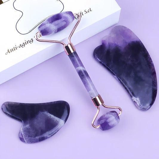 Amethyst facial roller set with heart-shaped gua sha and claw massage tools on white background
